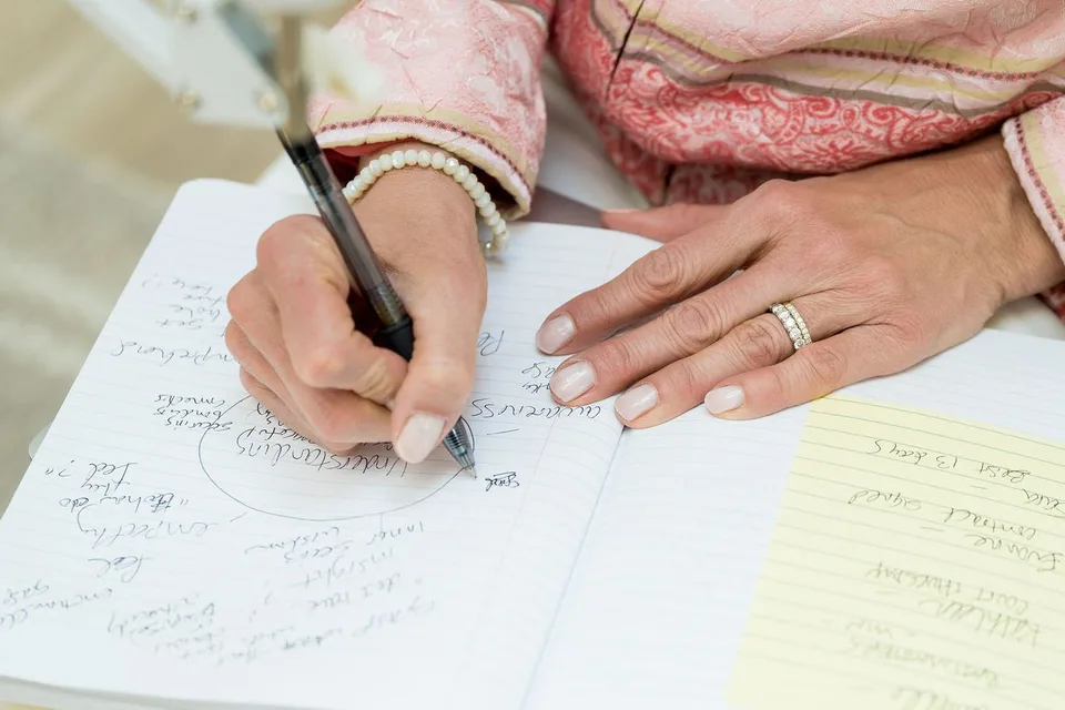Laura Burkey writing notes at a table